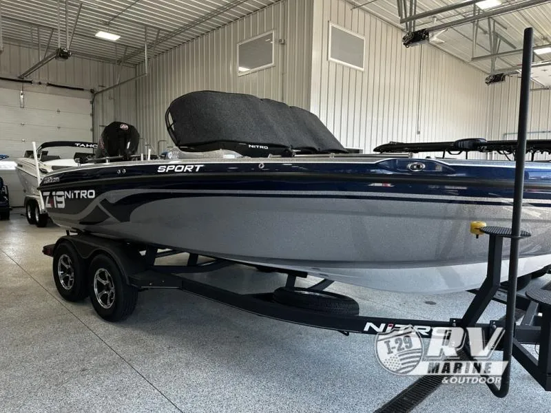 Slide: The Image of 2024 White River ZV19 boat in showroom, sleek design, dual-axle trailer. - 9