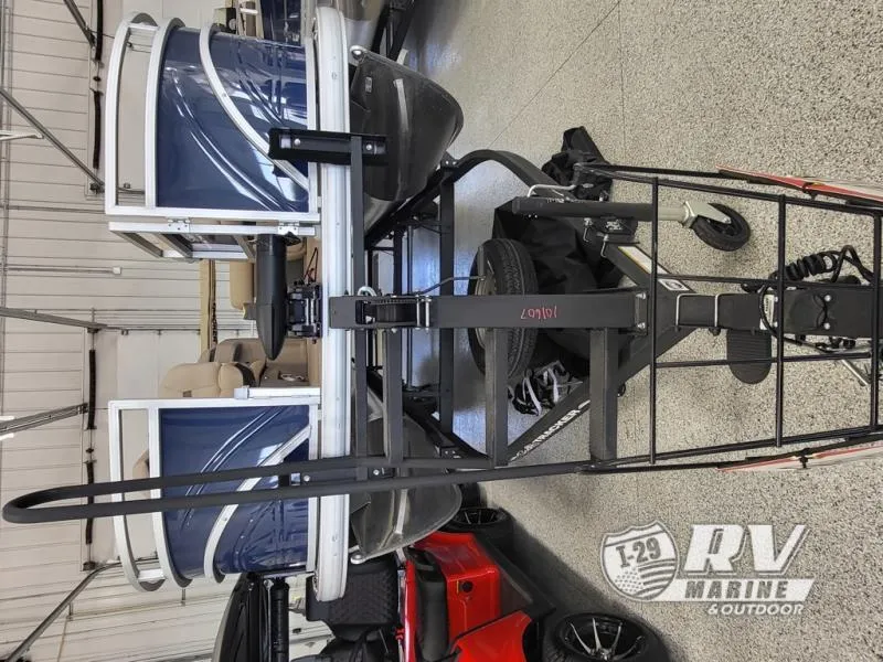Slide: The Image of 2024 Fishin Barge FB20 pontoon boat on trailer in showroom. - 4