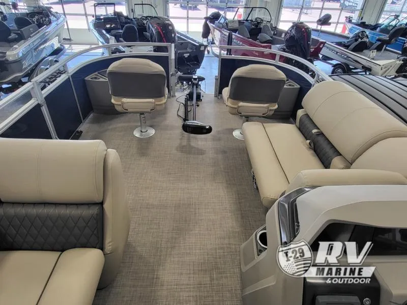 Slide: The Image of 2024 Fishin Barge FB20 interior with plush seating and modern design in showroom. - 5