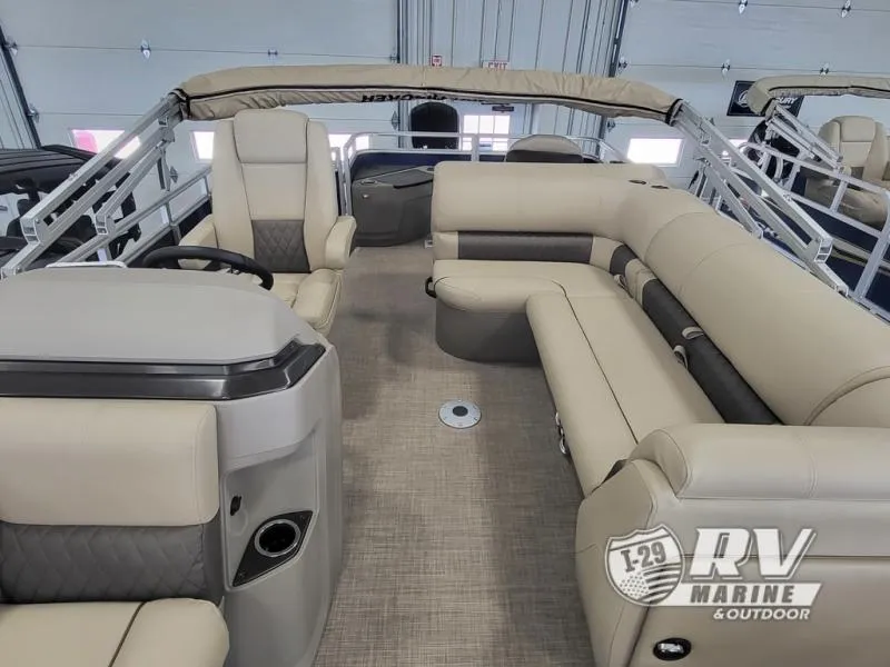 Slide: The Image of 2024 Fishin Barge FB20 interior with beige seating and steering console. - 6