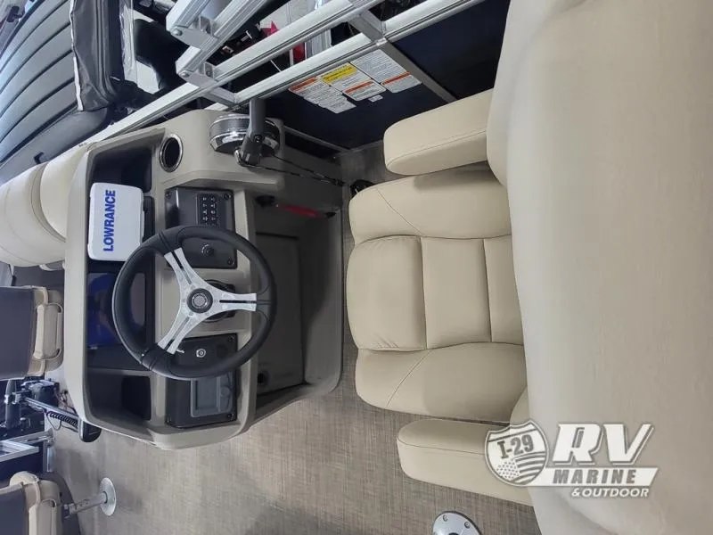 Slide: The Image of 2024 Fishin Barge FB20 interior with steering wheel and beige seating. - 7