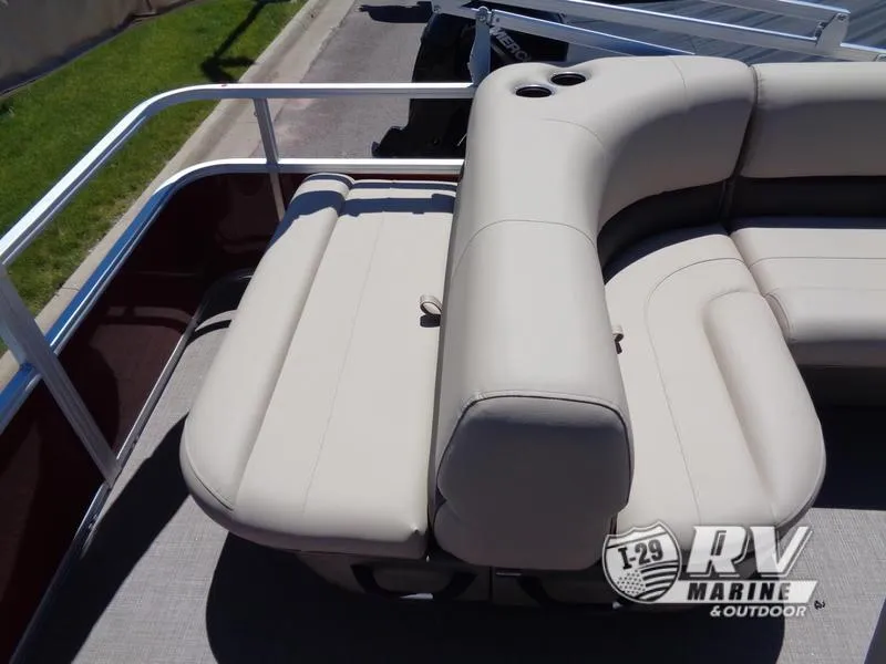 Slide: The Image of 2024 Party Barge 18DLX pontoon boat with beige seating and cup holders. - 14