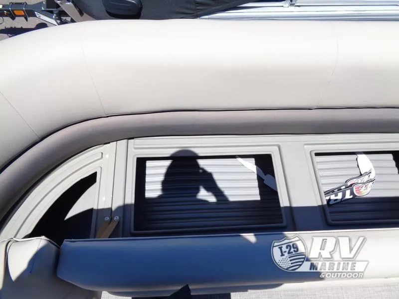 Slide: The Image of 2024 Party Barge 18DLX pontoon boat with shadow and RV Marine logo. - 7