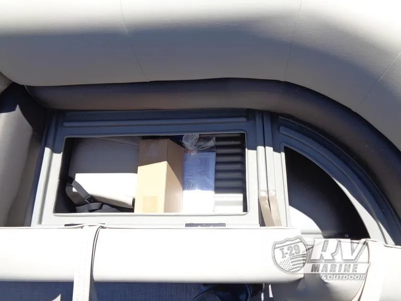 Slide: The Image of 2024 Party Barge 18DLX storage compartment with boxes and documents. - 8