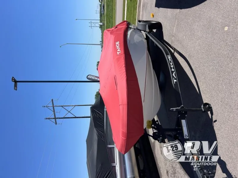Slide: The Image of 2024 TAH18J boat with red cover on trailer, sunny outdoor setting. - 7