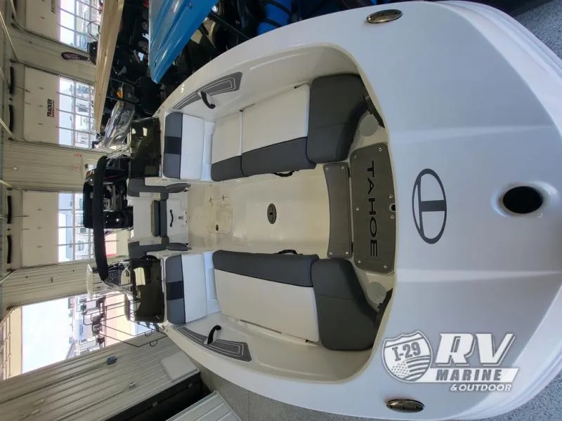 Slide: The Image of 2024 Tahoe T21 boat interior with gray and white seating in showroom. - 8