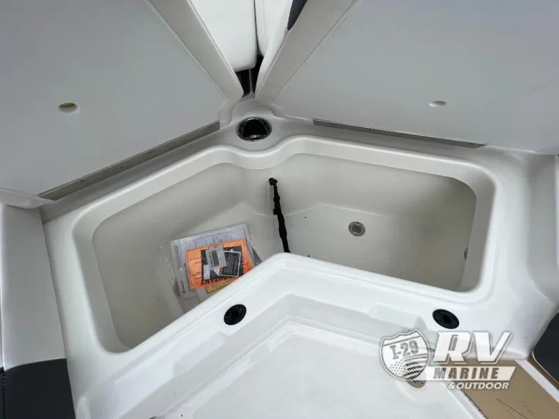Slide: The Image of 2024 Tahoe 210S boat storage compartment with open hatches and documents inside. - 11