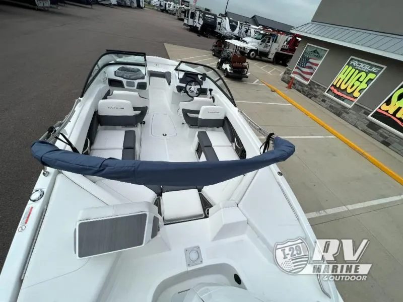 Slide: The Image of 2024 Tahoe 210S boat at dealership, showcasing spacious interior and modern design. - 14