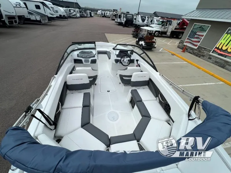 Slide: The Image of 2024 Tahoe 210S boat interior at RV Marine dealership, showcasing seating and steering area. - 16