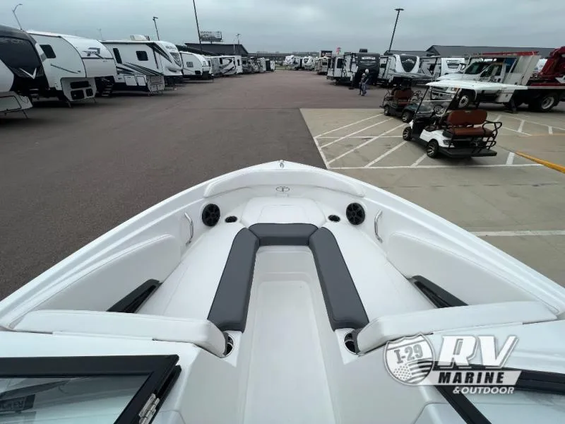 Slide: The Image of 2024 Tahoe 210S boat interior at RV Marine dealership, surrounded by RVs and vehicles. - 18