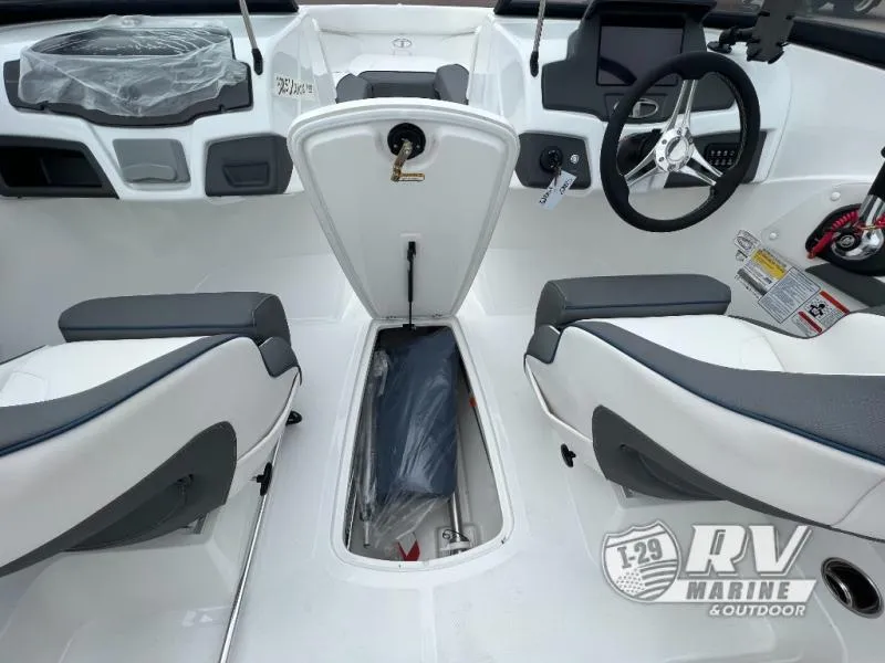 Slide: The Image of 2024 Tahoe 210S boat interior with storage compartment and steering wheel. - 7