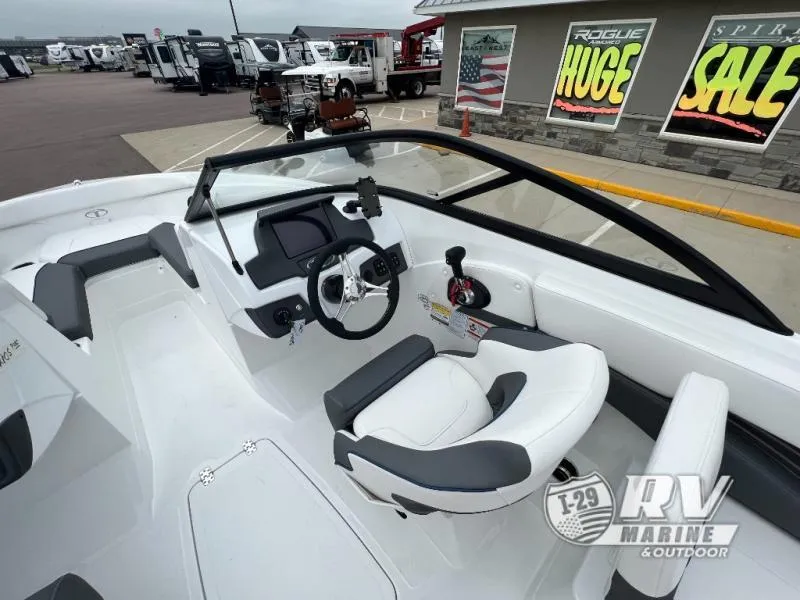 Slide: The Image of 2024 Tahoe 210S boat interior with steering wheel and seating at RV Marine dealership. - 8