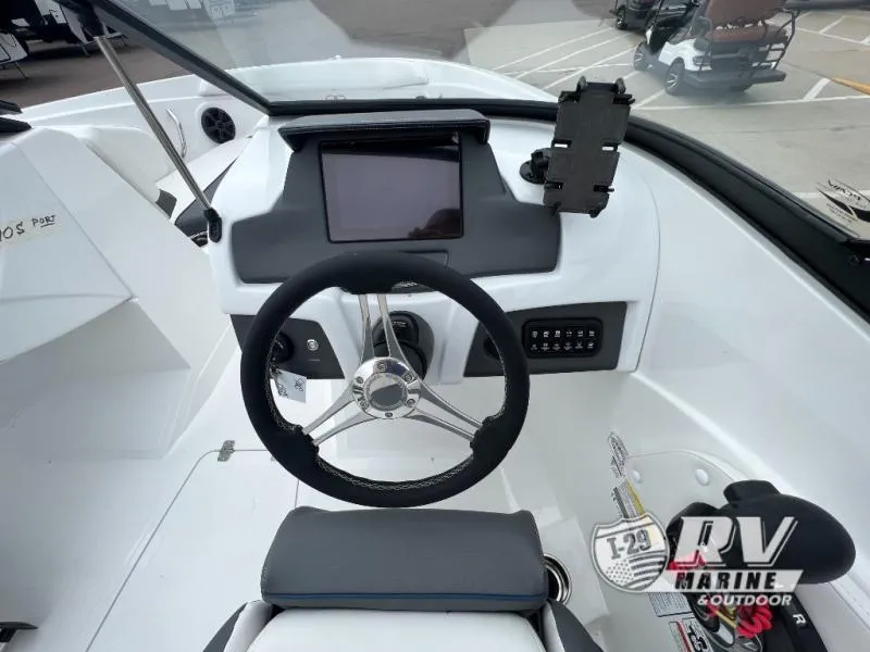 Slide: The Image of 2024 Tahoe 210S boat dashboard with steering wheel and control panel. - 9