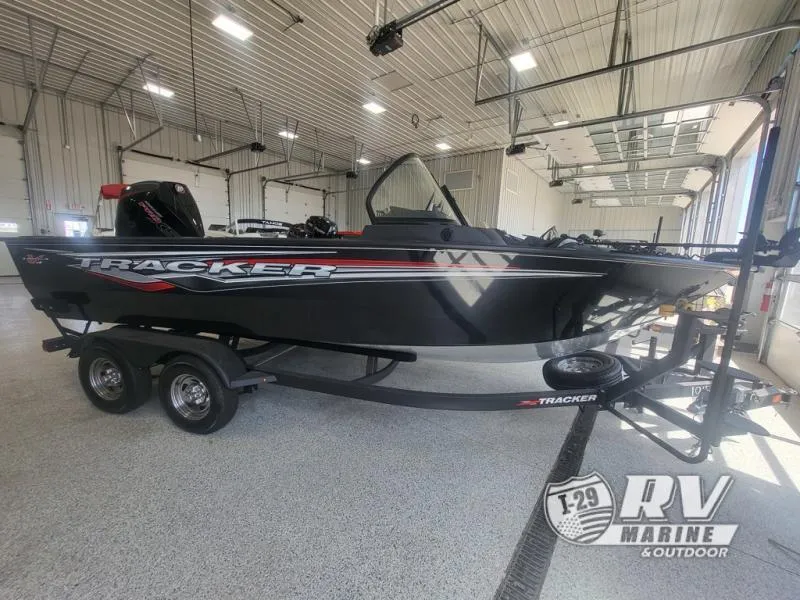 Slide: The Image of 2024 Targa V19 boat in showroom, black with red accents, on trailer. - 1