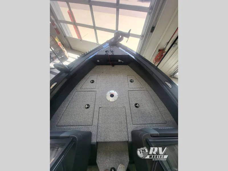 Slide: The Image of 2024 Targa V19 boat interior with carpeted deck in a garage setting. - 10