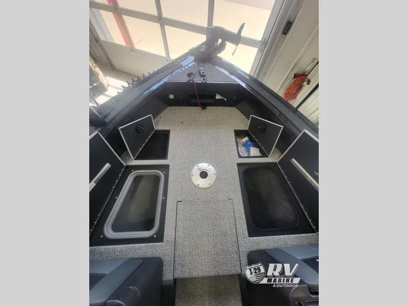 Slide: The Image of Interior of 2024 Targa V19 boat with storage compartments and carpeted flooring. - 11