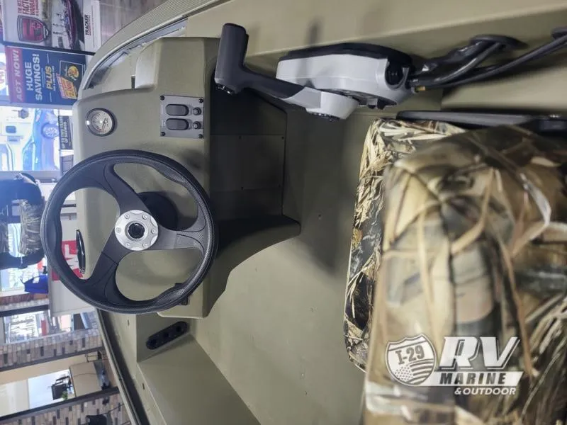 Slide: The Image of 2024 Tracker 1754SC boat interior with steering wheel and camo seat. - 3