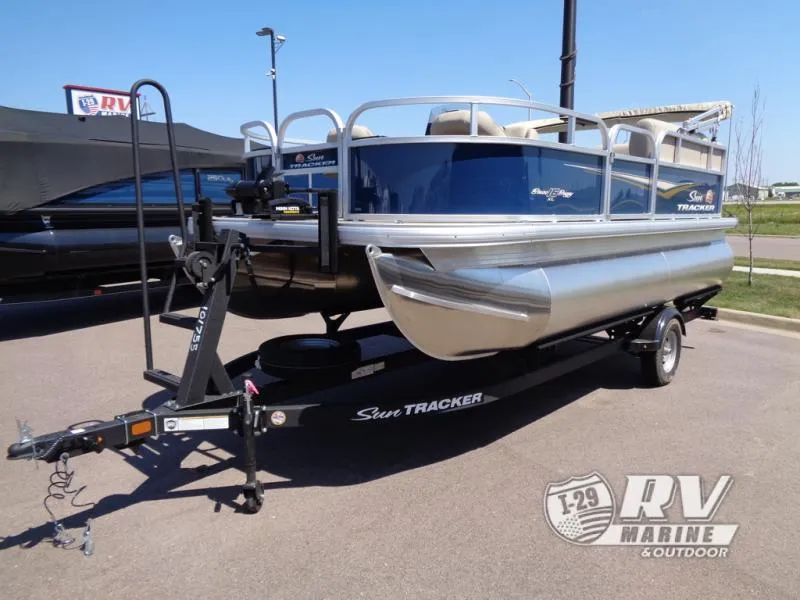 Slide: The Image of 2025 BASS BUGGY 16 XL Select pontoon boat on trailer, displayed outdoors. - 10