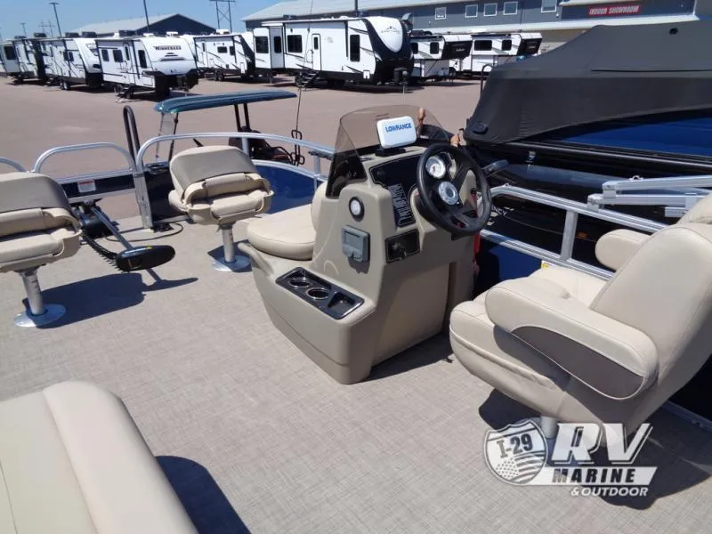 Slide: The Image of 2025 BASS BUGGY 16 XL Select pontoon boat interior with beige seating and steering console. - 16
