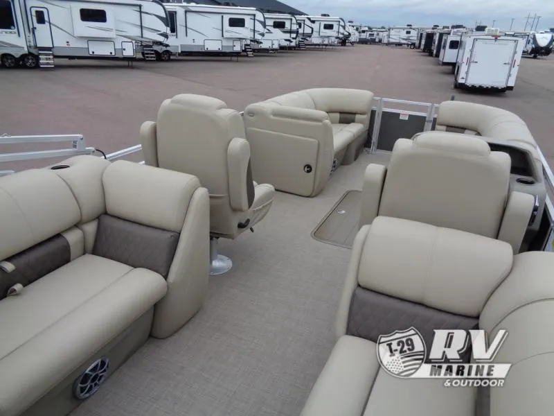 Slide: The Image of 2025 Party Barge PB22XP3 pontoon boat with beige seating, displayed at RV Marine dealership. - 23
