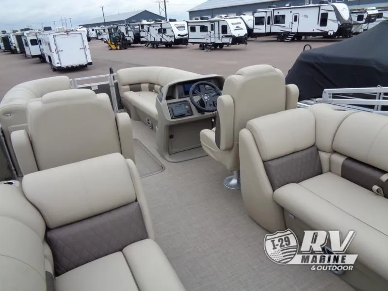 Slide: The Image of 2025 Party Barge PB22XP3 pontoon boat interior with beige seating at RV Marine dealership. - 24