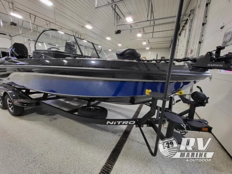 Slide: The Image of 2025 Nitro ZV21 boat in showroom, featuring sleek design and Garmin equipment. - 3