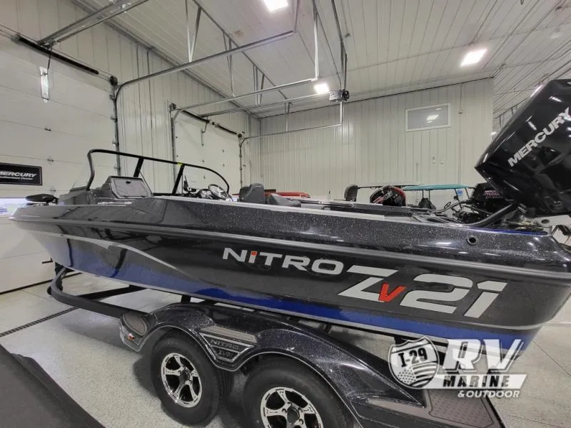 Slide: The Image of 2025 Nitro ZV21 boat in showroom, featuring sleek design and Mercury engine. - 4