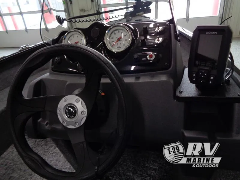 Slide: The Image of 2025 SUPER GUIDE SG16 boat dashboard with steering wheel and Garmin device. - 10