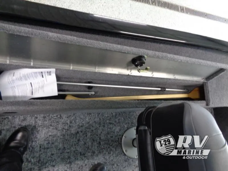 Slide: The Image of SUPER GUIDE SG16 2025 boat interior storage with documents and paddle, RV Marine branding. - 11