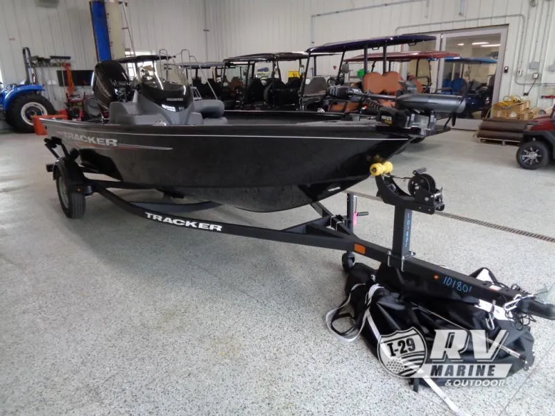 Slide: The Image of Black Tracker boat on trailer in showroom, SUPER GUIDE SG16, 2025 model. - 4
