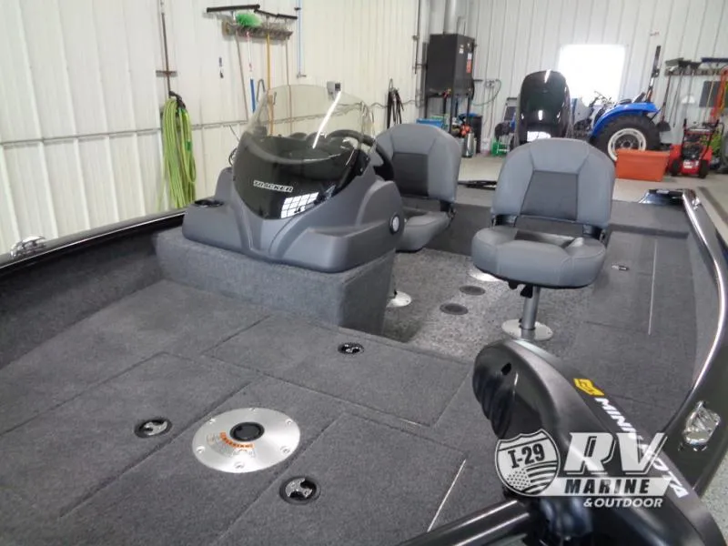 Slide: The Image of 2025 SUPER GUIDE SG16 boat interior with seating and console in a garage setting. - 8