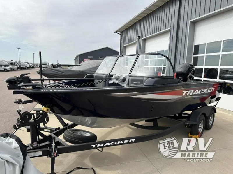 Slide: The Image of 2025 Targa 18 boat on trailer outside RV Marine store. - 1