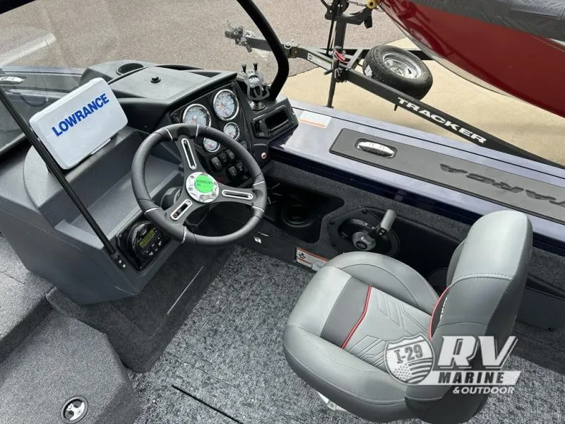 Slide: The Image of 2025 Targa 18 boat interior with steering wheel, Lowrance system, and comfortable seating. - 17