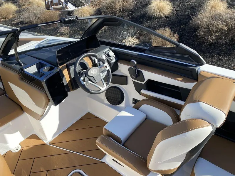 Slide: The Image of Interior of 2025 Malibu 23 LSV boat with modern dashboard and seating. - 14