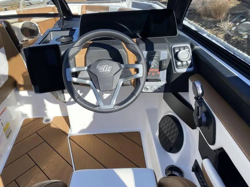 Slide: The Image of 2025 Malibu 23 LSV boat cockpit with modern steering wheel and control panel. - 15