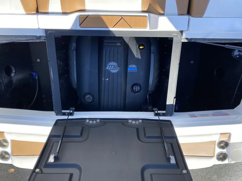 Slide: The Image of 2025 Malibu 23 LSV boat engine compartment, open hatch, showcasing interior components. - 2