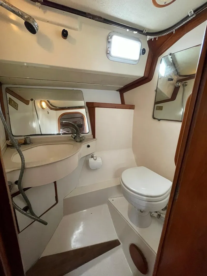 Slide: The Image of 1984 Belliure Sloop bathroom interior with sink, toilet, and mirrors. - 8