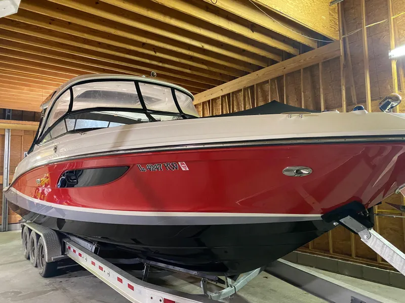 The Image of 2017 Sea Ray 350 SLX boat in storage, red and black exterior, on a trailer. - 0