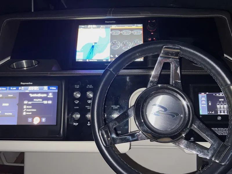 Slide: The Image of 2017 Sea Ray 350 SLX dashboard with navigation screens and steering wheel. - 12
