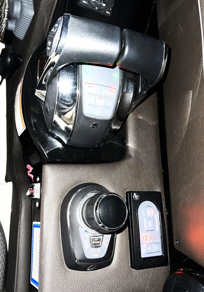 Slide: The Image of Control panel of a 2017 Sea Ray 350 SLX boat with throttle and joystick. - 13