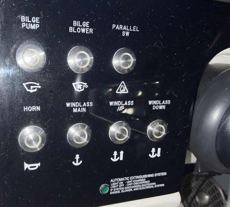 Slide: The Image of Control panel of a 2017 Sea Ray 350 SLX boat with various switches. - 14