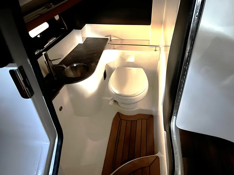 Slide: The Image of 2017 Sea Ray 350 SLX boat bathroom with sink and toilet. - 17