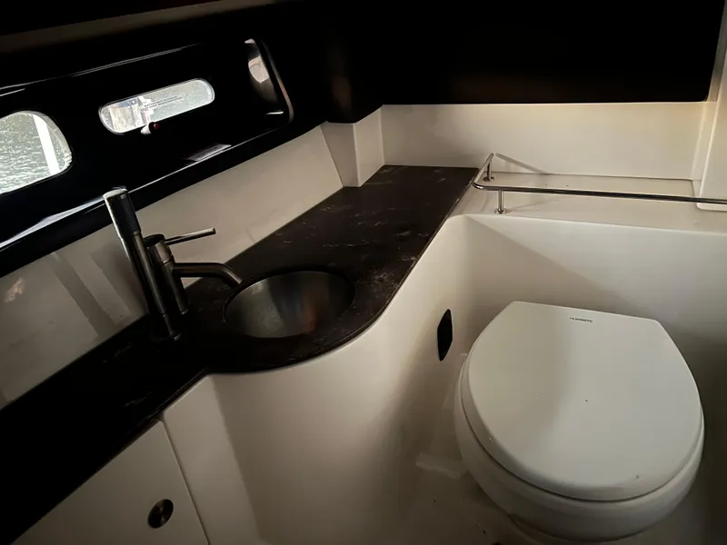 Slide: The Image of 2017 Sea Ray 350 SLX boat bathroom with sink and toilet. - 18