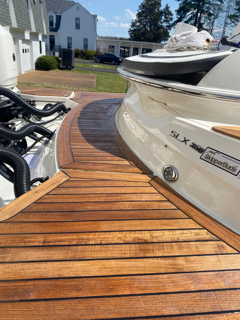 Slide: The Image of 2017 Sea Ray 350 SLX boat with wooden deck, parked in residential area. - 20