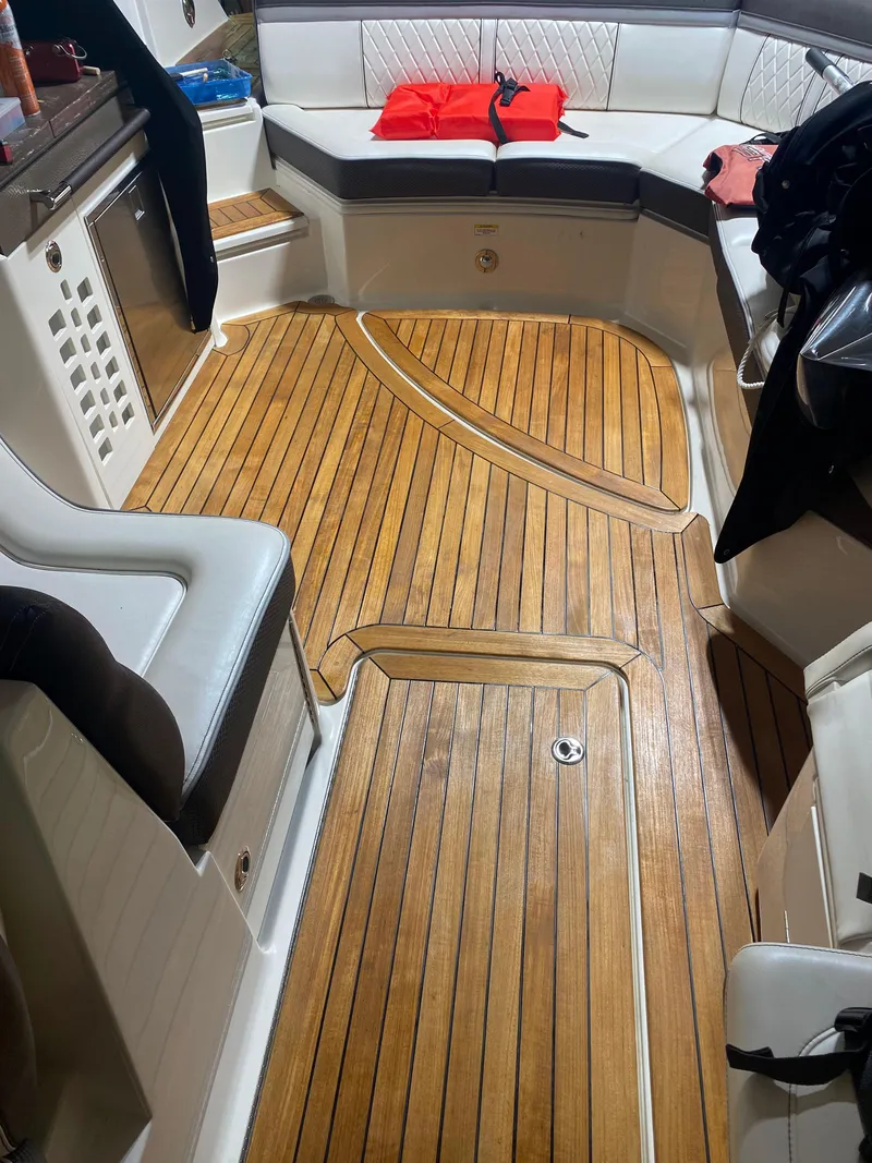Slide: The Image of Interior of 2017 Sea Ray 350 SLX boat with teak flooring and cushioned seating. - 21