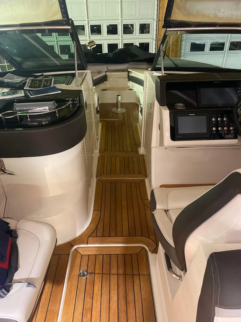 Slide: The Image of 2017 Sea Ray 350 SLX boat interior with wood flooring and modern controls. - 22