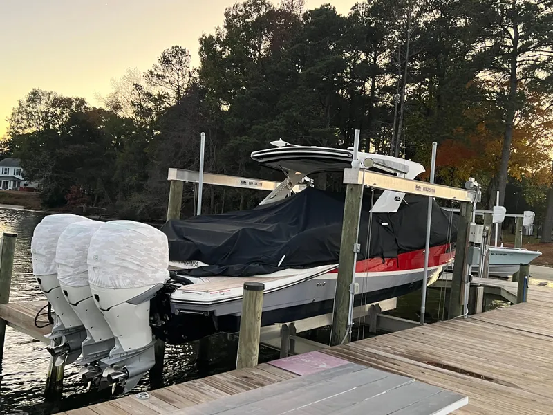 Slide: The Image of 2017 Sea Ray 350 SLX boat docked with triple outboard engines, covered and elevated. - 26