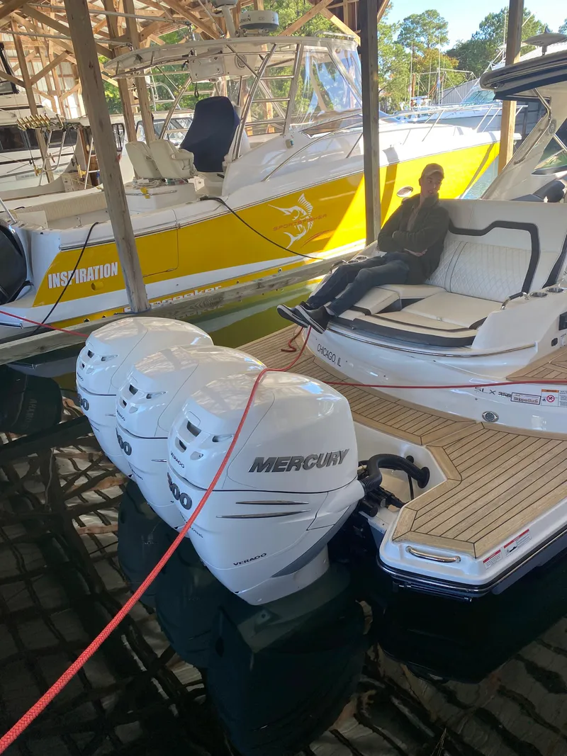 Slide: The Image of 2017 Sea Ray 350 SLX with triple Mercury outboards docked in marina. - 30