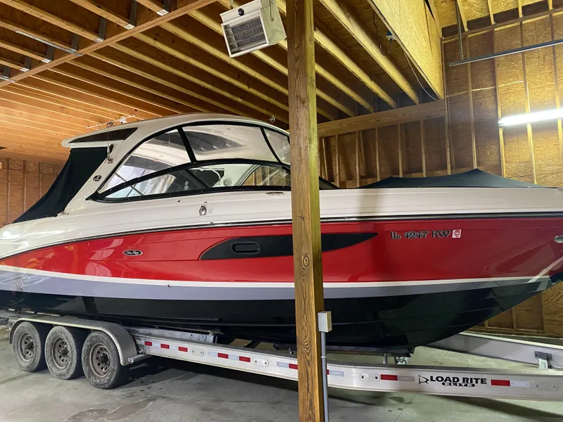 Slide: The Image of 2017 Sea Ray 350 SLX boat in storage on a trailer. - 32