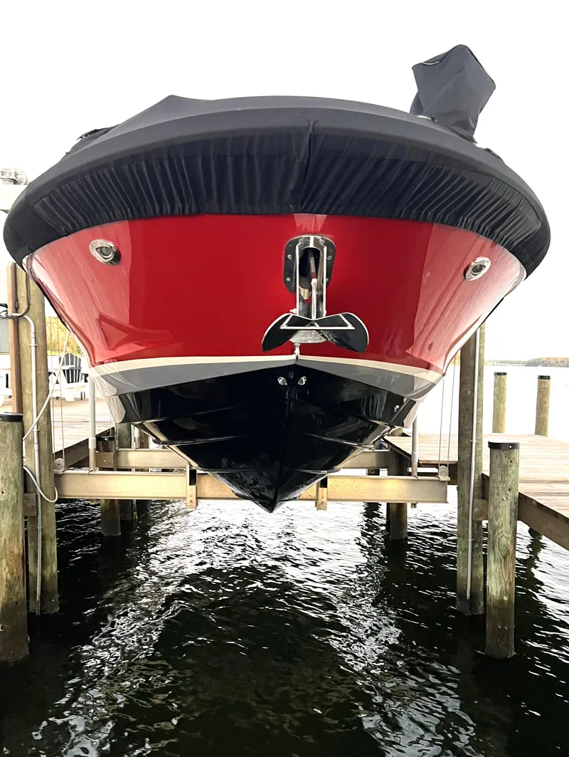 Slide: The Image of 2017 Sea Ray 350 SLX boat docked, red and black hull, front view. - 37